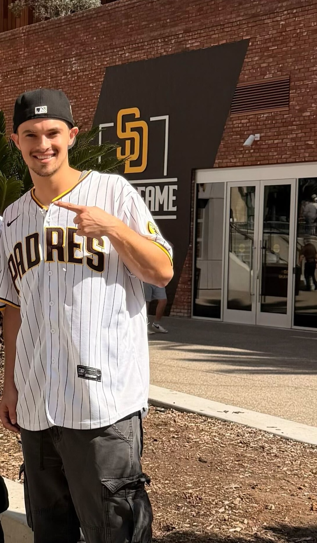 Ryan in a Padres jersey in front of Petco Park.